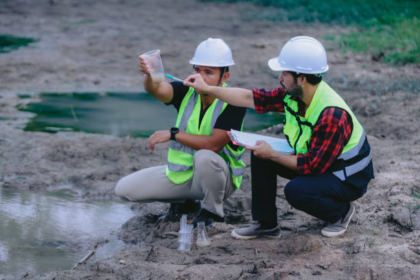 istock Environmental engineers work at wastewater treatment plants,Water supply engineering working at Water recycling plant for reuse,Technicians and engineers discuss work together 2154452167