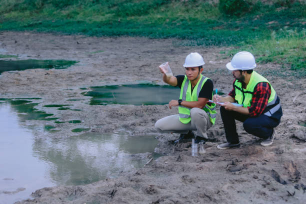 istock Environmental engineers work at wastewater treatment plants,Water supply engineering working at Water recycling plant for reuse,Technicians and engineers discuss work together 2154452175