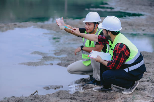istock Environmental engineers work at wastewater treatment plants,Water supply engineering working at Water recycling plant for reuse,Technicians and engineers discuss work together 2154452186