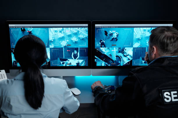 istock Two officers watching cctv video cameras 2154453359