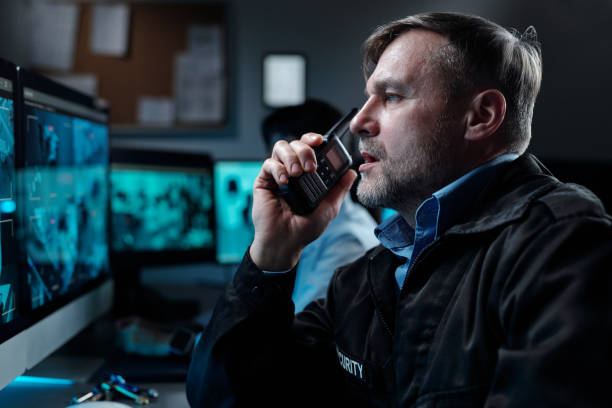 istock Male guard with walkie-talkie by mouth 2154453516