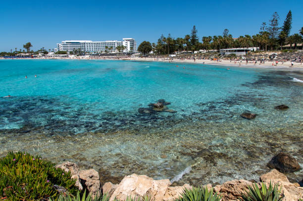Nissi Beach, Ayia Napa, Cyprus; May 7th, 2024: Blue lagoon of Nissi Beach with turquoise water and landmark hotels in the waterfront
