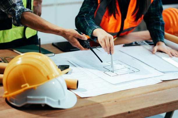 istock Engineer teams meeting working together wear worker helmets hardhat on construction site in modern city.Asian industry professional team. 2154459133