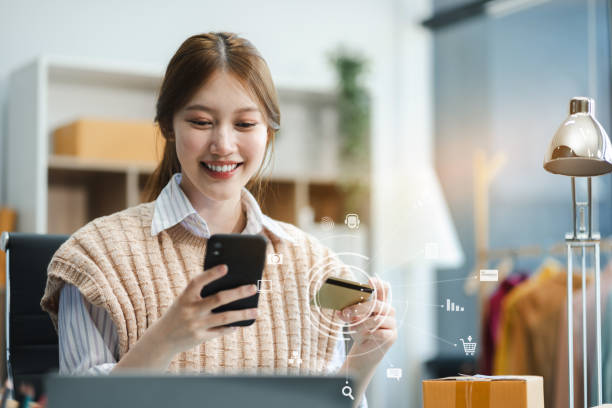 istock Hands holding credit card and using smartphone in home. Online shopping. 2154459176