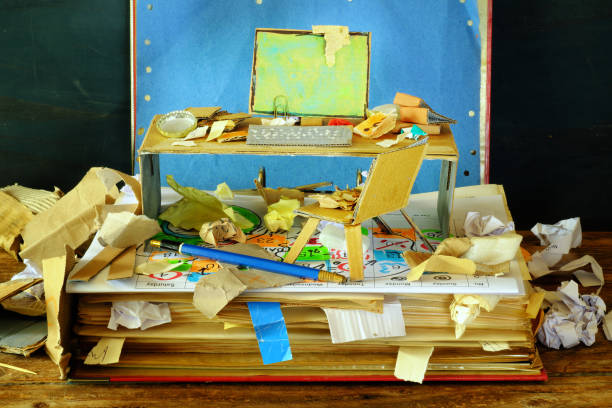 Messy workplace,chaotic office, overworked, burnout,bureaucracy,red tape concept with grungy file folders,littered workplace with grungy cardboard models