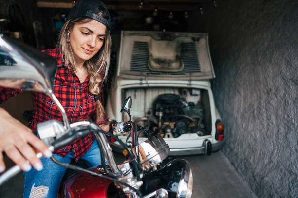 istock young woman repair old timer motorcycle 2154460186