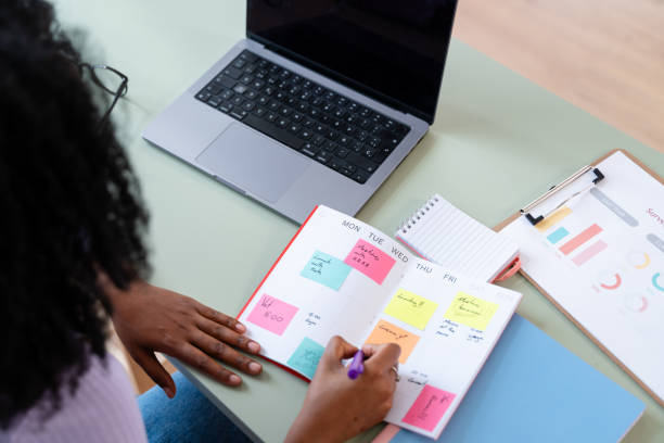 istock Businesswoman organizing weekly schedule on planner 2154460573