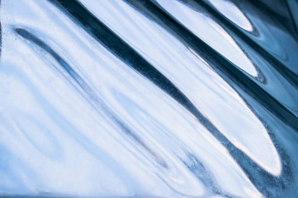 Blured abstract blue background and texture. It is caused by light passing through a glass.