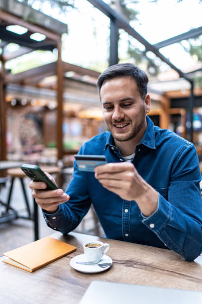 istock Young man shopping online or checking bank account using cell phone 2154463399