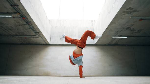 istock Dancing man enjoy practice break dance or freestyle in building. Sprightly. 2154466185
