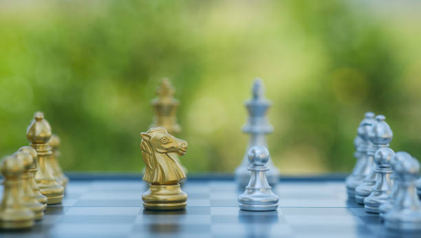 istock gold  knight Against whithe background, International chess, ideas and competition and strategy, chess board game competition business concept. 2154467261