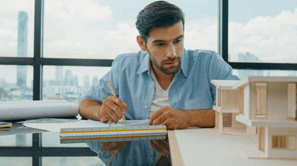 istock Skilled architect engineer designs house construction on blueprint. Tracery 2154469465