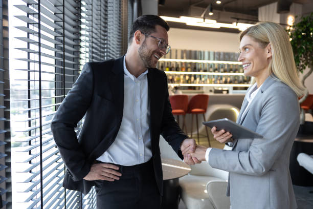 istock Professional businessman and woman using tablet while working together 2154471891