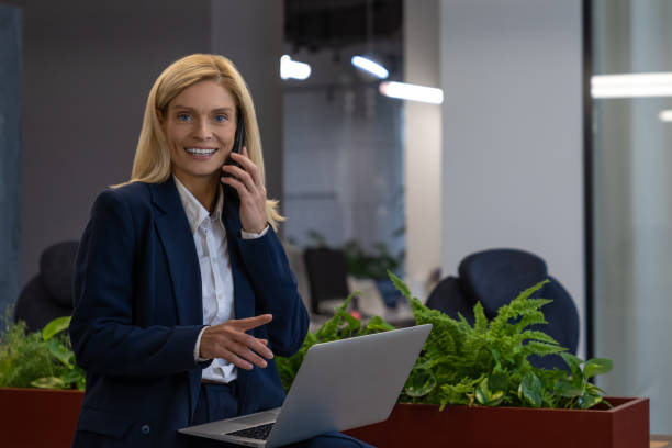 istock Confident woman working on laptop and having professional conversation 2154472052