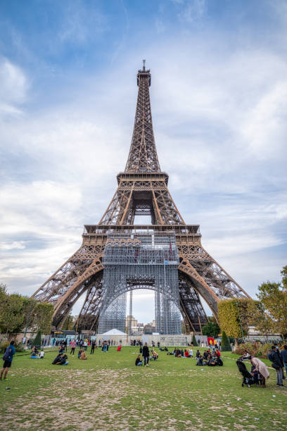 October 17, 2021 - Paris, France: world-famous, tourists-packed, the French Eiffel tower under maitenance never ceases to impress and this underside photograph taken with an ultrawide lens shows a majestic perspective. Usual tourists, barely recognizable, stay under the immense steel structure at champ de mars