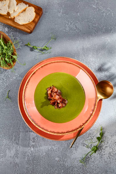 istock Broccoli cream soup with crispy bacon topping on rustic ceramic, top view for a healthy and hearty meal 2154473827