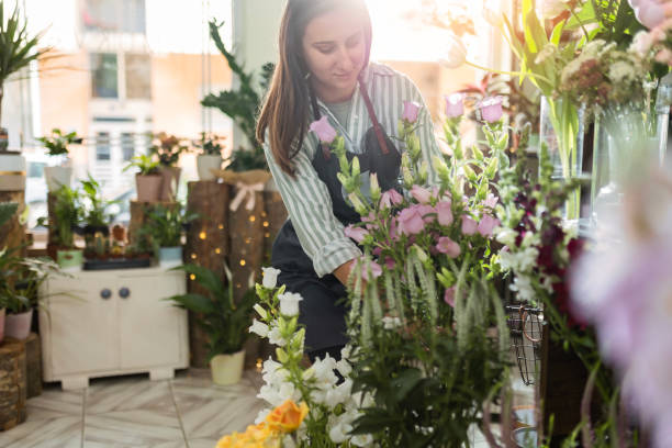 istock Beautiful Woman Working with Flowers 2154475597