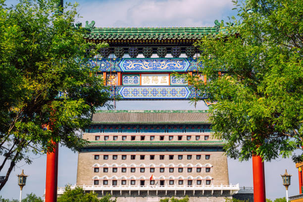 Detailed shot of traditional Chinese architecture in Beijing, China, showcasing intricate designs and cultural heritage under a clear blue sky.Zhengyangmen was first built in 1419 during the Ming dynasty