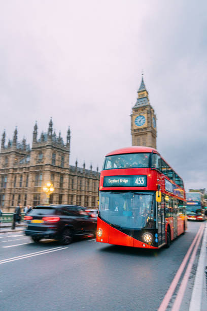 istock Red Double Decker Bus in London passing Big Ben 2154477159