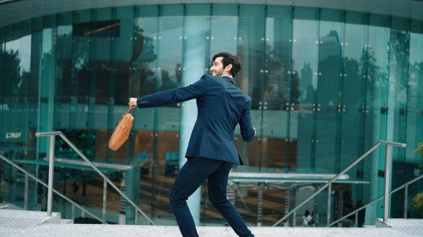 istock Successful businessman celebrate for getting promotion while walking. Exultant. 2154477330