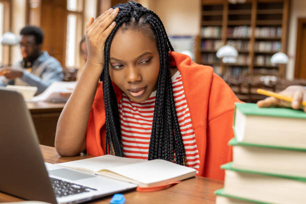 istock Long-haired young woman studying in the library 2154478968