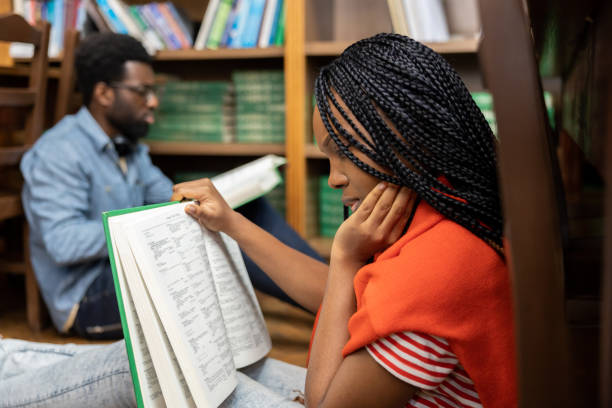 istock Young people studying in the library together and looking involved 2154479002