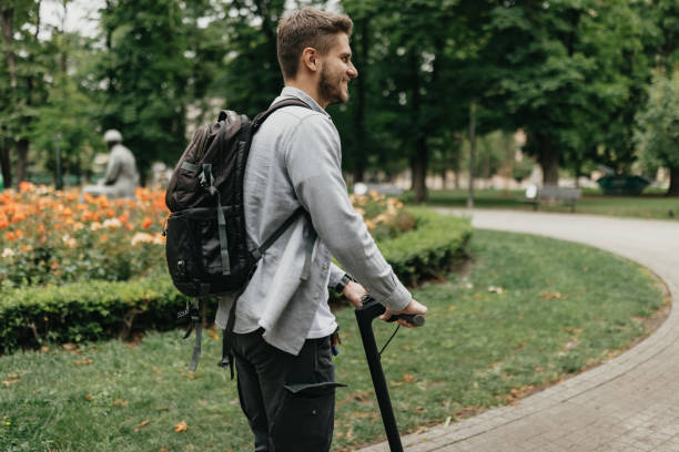 istock Man riding an electric scooter in a park 2154483961