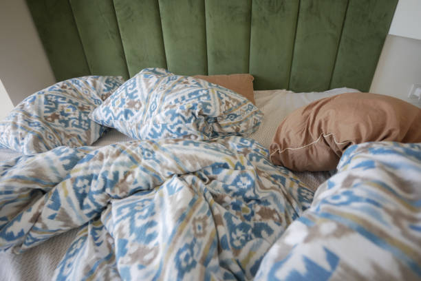 istock messy bed in early morning , messy bed after waking up 2154484038