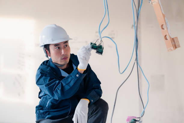 istock Electrician working on wiring at construction site 2154485172