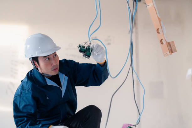istock Electrician working on wiring at construction site 2154485174