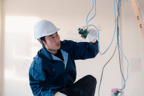 istock Electrician working on wiring at construction site 2154485178