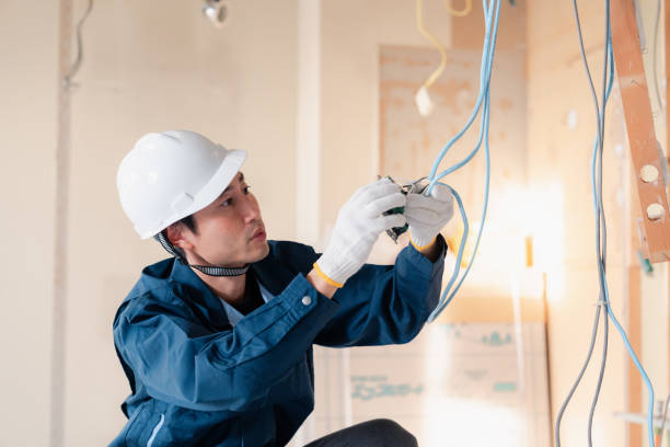 istock Electrician working on wiring at construction site 2154485194