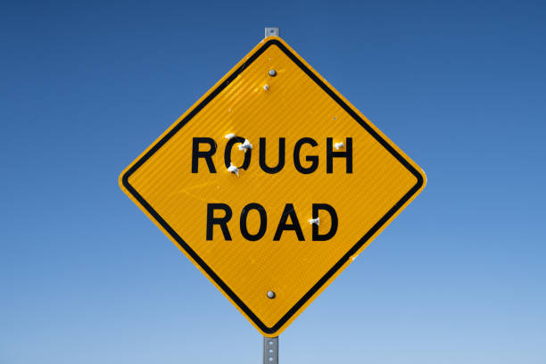 istock Rough Road Sign with Bullet Holes 2154488387