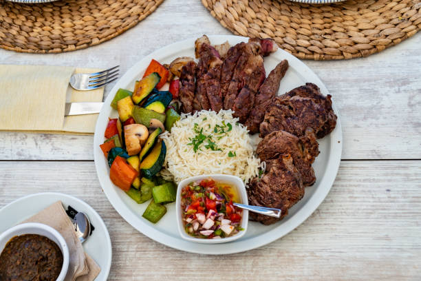 istock Mixed barbecue grilled meats served with rice and vegetables 2154488510