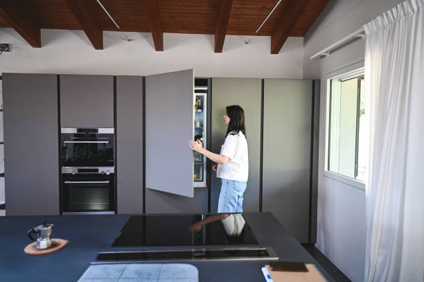 istock Young woman looking into fridge. 2154489535