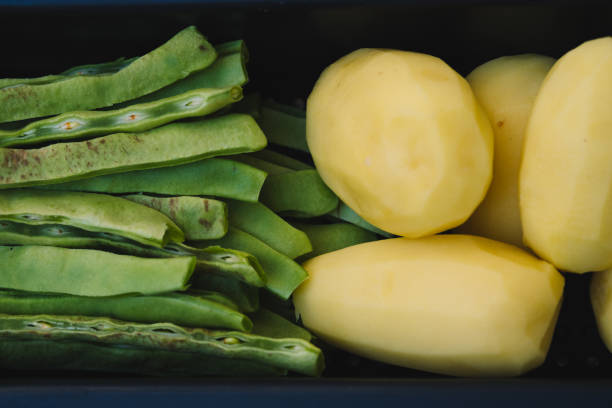 Table where beans and potatoes are being prepared.