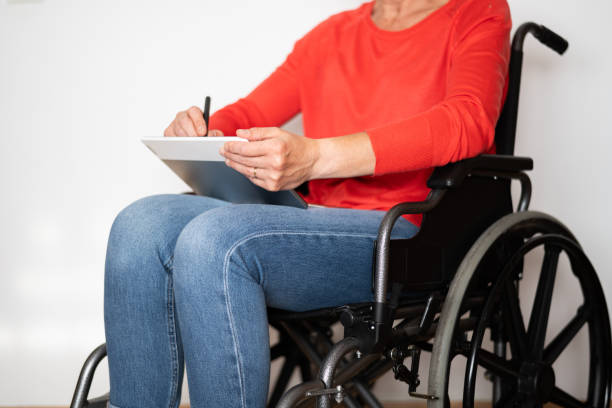 istock Graphic Design Professional in a Wheelchair Using a Digital Tablet or Graphic Tablet Drawing with a Pencil. 2154496974