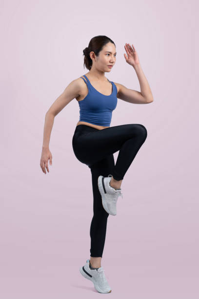 istock Side view young athletic asian woman on running posture. Vigorous 2154497032