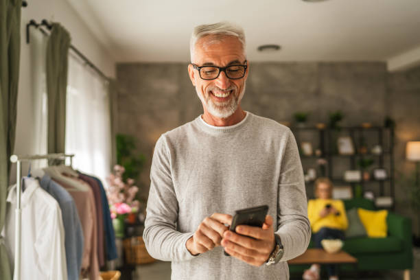 istock One mature man hold mobile phone and explore internet or text message 2154498782