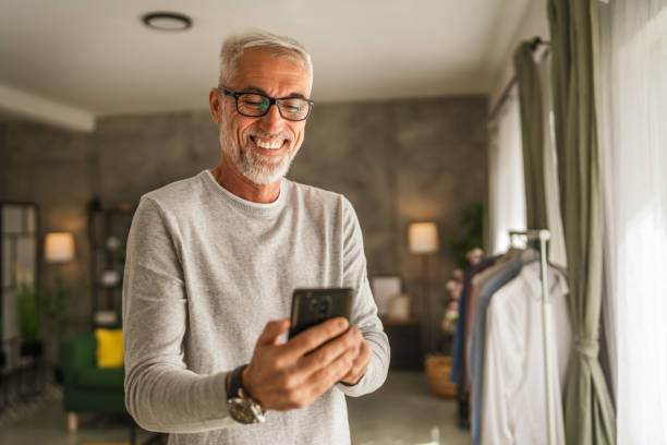 istock One mature man hold mobile phone and explore internet or text message 2154499539
