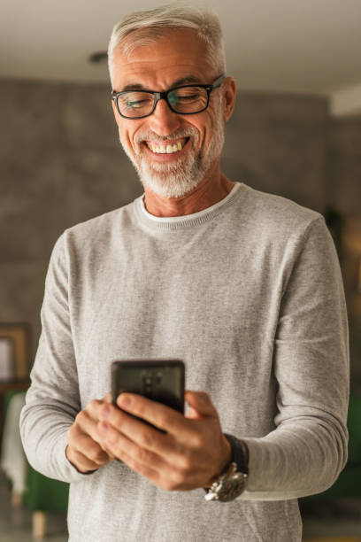 istock One mature man hold mobile phone and explore internet or text message 2154499616