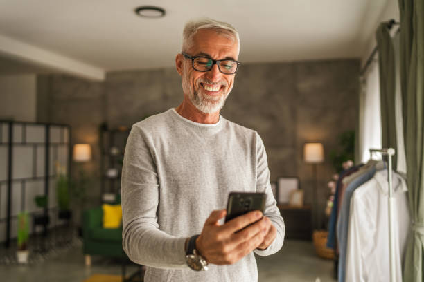 istock One mature man hold mobile phone and explore internet or text message 2154499745