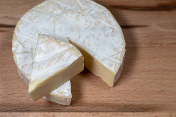 istock fresh brie cheese on a wooden background. High quality photo 2154504839