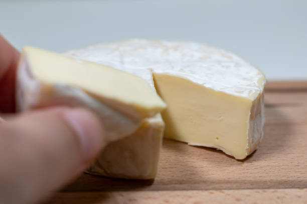 istock fresh brie cheese on a wooden background. High quality photo 2154504864