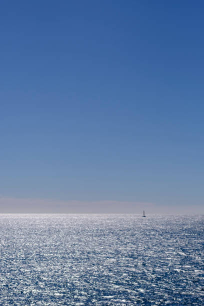 istock Tiny boat sailing on quiet blue waters in Mediterranean Sea summer beach holidays blue seascape 2154506925