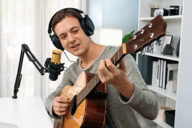 istock Singer with smile face on social media, playing guitar along singing. Pecuniary. 2154507780