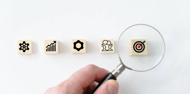 istock Business target board print screen on wooden cube block among graph mechanical gear and people for Business Achievement objective target concept 2154510327