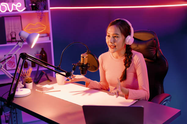 istock Smiling creative young beautiful Asian influencer talking in channel. Stratagem. 2154511082