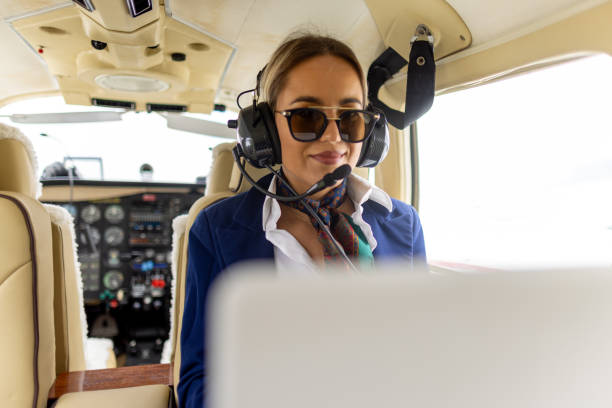 istock Stewardesses sitting in an airplane, typing on her laptop 2154513137