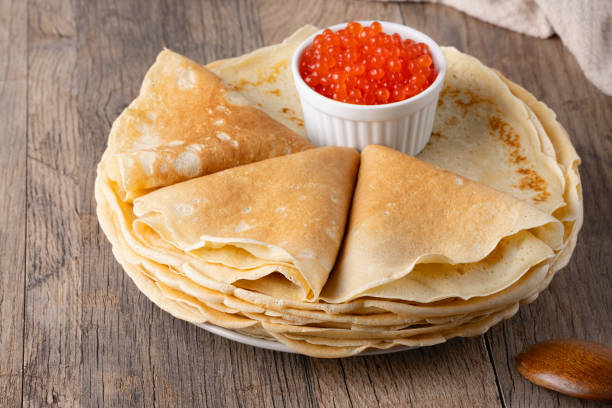 istock Pancakes with red caviar on a wooden table 2154513483